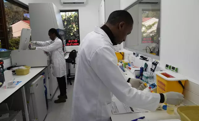 Lab technician Xolile Mhlanga works with vials of lenacapavir at the Desmond Tutu Health Foundation's Masiphumelele Research Site, in Cape Town, South Africa, Tuesday, July 23, 2024. Twice-yearly shots of the drug used to treat AIDS were 100% effective in preventing new infections in women, according to study results published Wednesday. (AP Photo/Nardus Engelbrecht)