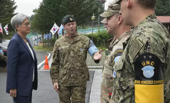 Australian Foreign Minister Penny Wong, left, is escorted by UNC DCDR Derek Allen Macaulay, second from left, before visiting the truce village of Panmunjom in the Demilitarized Zone (DMZ) on the border between North and South Korea, at the JSA Visitor Center in Paju, South Korea, Tuesday, July 30, 2024. (AP Photo/Ahn Young-joon)