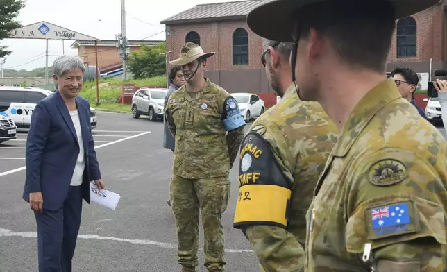 Australian Foreign Minister Penny Wong, left, talks with UNCMAC Australian soldiers after visiting the truce village of Panmunjom in the Demilitarized Zone (DMZ) on the border between North and South Korea, at the JSA Visitor Center in Paju, South Korea, Tuesday, July 30, 2024. (AP Photo/Ahn Young-joon)