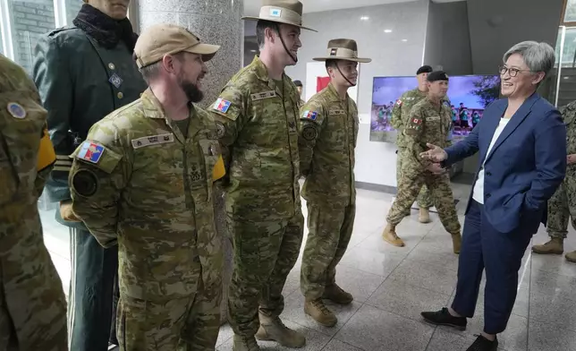 Australian Foreign Minister Penny Wong, right, talks with UNCMAC Australian soldiers before visiting the truce village of Panmunjom in the Demilitarized Zone (DMZ) on the border between North and South Korea, at the JSA Visitor Center in Paju, South Korea, Tuesday, July 30, 2024. (AP Photo/Ahn Young-joon)