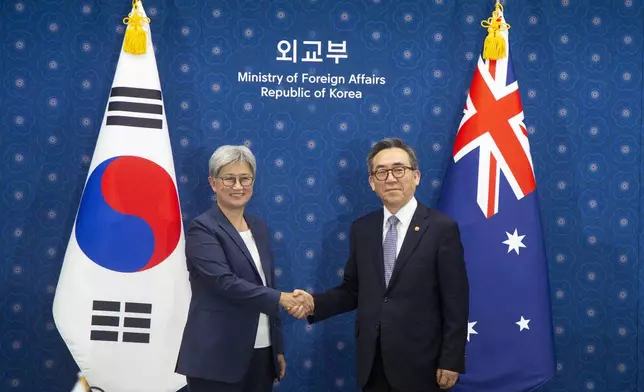 Australian Foreign Minister Penny Wong shakes hands with South Korean Foreign Minister Cho Tae-yul prior to their meeting at the foreign ministry in Seoul, South Korea, Tuesday, July 30, 2024. (Jeon Heon-kyun/Pool Photo via AP)