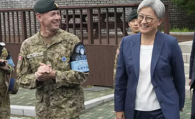 Australian Foreign Minister Penny Wong, right, is escorted by UNC DCDR Derek Allen Macaulay before visiting the truce village of Panmunjom in the Demilitarized Zone (DMZ) on the border between North and South Korea, at the JSA Visitor Center in Paju, South Korea, Tuesday, July 30, 2024. (AP Photo/Ahn Young-joon)