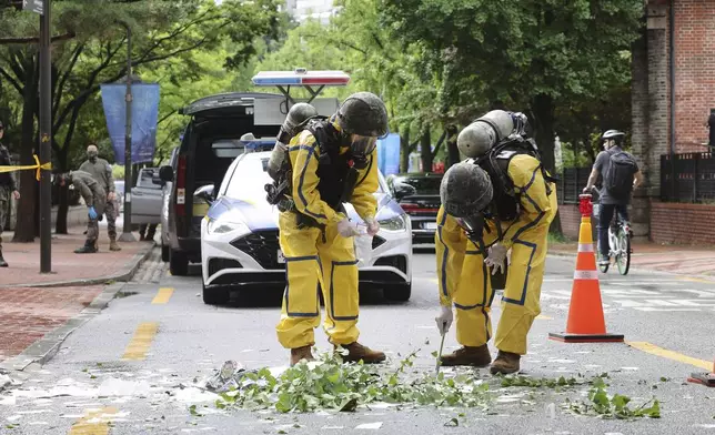 South Korean army soldiers wearing protective gear checks the debreis from a balloon presumably sent by North Korea, Wednesday, July 24, 2024, in Seoul, South Korea. (Park Dong-joo/Yonhap via AP)