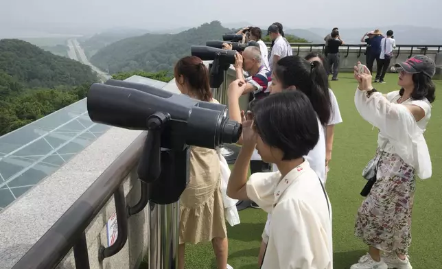 Visitors watch North Korean side from the Unification Observation Post in Paju, South Korea, near the border with North Korea, Friday, July 19, 2024. South Korea said Friday it has restarted blasting propaganda broadcasts into North Korea to retaliate against the North's latest round of trash-carrying balloon launches, a resumption of Cold War-style tactics that are raising animosities between the rivals. (AP Photo/Ahn Young-joon)