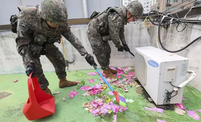 South Korean army soldiers collect the trash from a balloon presumably sent by North Korea, in Incheon, South Korea, Wednesday, July 24, 2024. (Lim Sun-suk//Yonhap via AP)