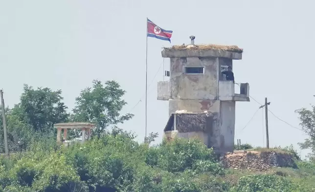 FILE - A North Korean soldier stands at the North's military guard post as a North Korean flag flutters in the wind, seen from Paju, South Korea, Wednesday, June 26, 2024. South Korea says North Korea has again flown balloons likely carrying trash toward South Korea. South Korea’s Joint Chiefs of Staff says the balloons are flying north of Seoul on Wednesday, July 24, 2024, after crossing the border. (AP Photo/Lee Jin-man, File)