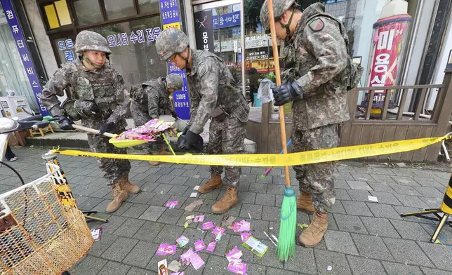 South Korean army soldiers collect the trash from a balloon presumably sent by North Korea, in Incheon, South Korea, Wednesday, July 24, 2024. (Lim Sun-suk//Yonhap via AP)