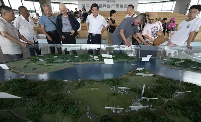 Visitors look at a map of the two Koreas borderland at the Unification Observation Post in Paju, South Korea, near the border with North Korea, Friday, July 19, 2024. South Korea said Friday it has restarted blasting propaganda broadcasts into North Korea to retaliate against the North's latest round of trash-carrying balloon launches, a resumption of Cold War-style tactics that are raising animosities between the rivals.(AP Photo/Ahn Young-joon)