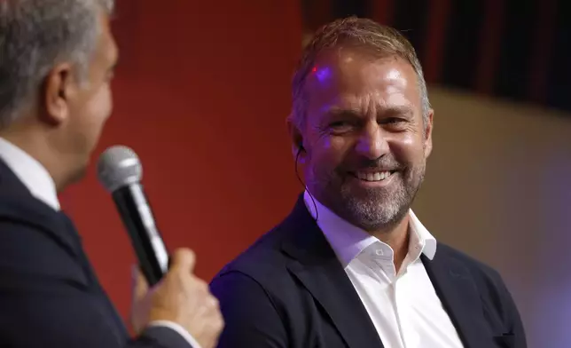 Barcelona's new coach Hansi Flick and Barcelona FC President, Joan Laporta, during an official presentation event of the new coach in Barcelona, Spain, Thursday, July 25, 2024. FC Barcelona and Hansi Flick have reached an agreement for the German to become men's first team football coach until 30 June 2026. (AP Photo/Joan Monfort)