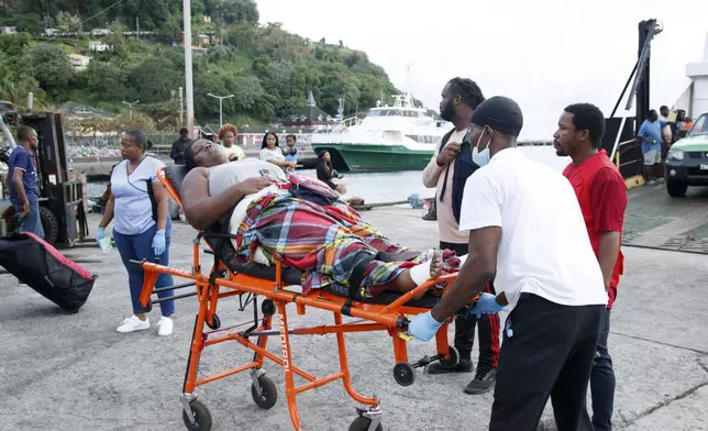 Members of the Red Cross transport a Union Island evacuee on a stretcher as she arrives in Kingstown, St. Vincent and the Grenadines, Wednesday, July 3, 2024. The island, in the Grenadines archipelago, was hit by Hurricane Beryl. (AP Photo/Lucanus Ollivierre)