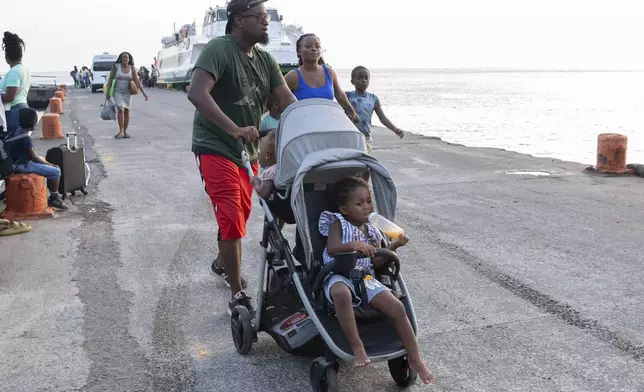 Evacuees from Union Island arrive in Kingstown, St. Vincent and the Grenadines, Tuesday, July 2, 2024. The island, in the Grenadines archipelago, was hit by Hurricane Beryl. (AP Photo/Lucanus Ollivierre)