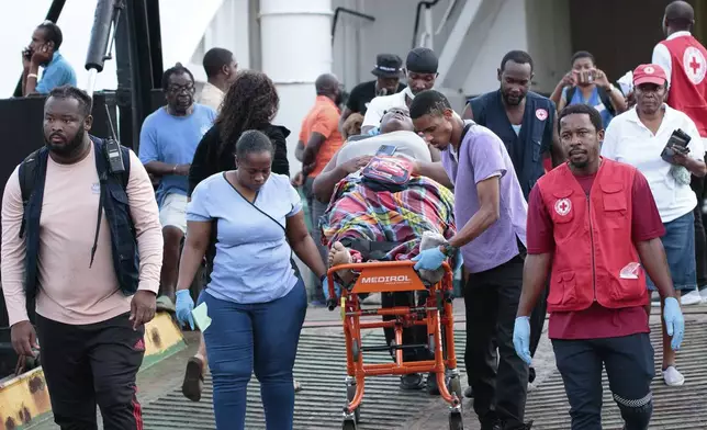 Members of the Red Cross transport a Union Island evacuee on a stretcher as she arrives in Kingstown, St. Vincent and the Grenadines, Wednesday, July 3, 2024. The island, in the Grenadines archipelago, was hit by Hurricane Beryl. (AP Photo/Lucanus Ollivierre)