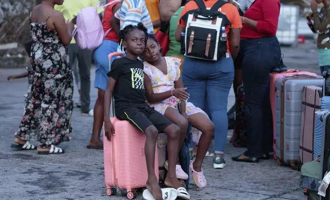Evacuees from Union Island arrive in Kingstown, St. Vincent and the Grenadines, Wednesday, July 3, 2024. The island, in the Grenadines archipelago, was hit by Hurricane Beryl. (AP Photo/Lucanus Ollivierre)