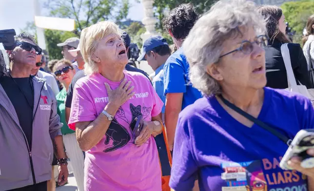 Celeste McCall, left, of Washington, reacts in confusion, Monday, July 1, 2024, outside the Supreme Court in Washington. "I'm confused I was told [Trump] has no immunity for unofficial acts," says McCall, "I don't even know what that means I'm beyond confused." (AP Photo/Jacquelyn Martin)
