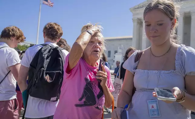 Celeste McCall, center, of Washington, reacts in confusion, Monday, July 1, 2024, outside the Supreme Court in Washington. "I'm confused I was told [Trump] has no immunity for unofficial acts," says McCall, "I don't even know what that means I'm beyond confused." (AP Photo/Jacquelyn Martin)