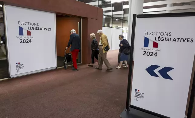 French people living in Switzerland arrive to cast their ballots for the second round of French legislative elections at the polling station "Palexpo" in Geneva, Switzerland, Sunday, July 7, 2024. (Martial Trezzini/Keystone via AP)