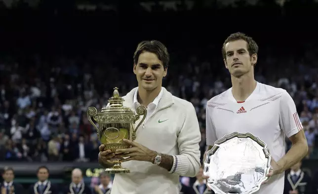 FILE - Roger Federer of Switzerland, left, poses with the winner's trophy alongside Andy Murray of Britain following the men's singles final match at the All England Lawn Tennis Championships at Wimbledon, England, Sunday, July 8, 2012. Murray will play only doubles at his last appearance at the All England Club following his withdrawal from singles after back surgery. (AP Photo/Kirsty Wigglesworth, File)