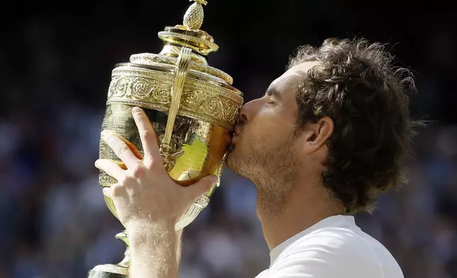 FILE - Andy Murray of Britain kisses his trophy after beating Milos Raonic of Canada in the men's singles final on day fourteen of the Wimbledon Tennis Championships in London, Sunday, July 10, 2016. Murray will play only doubles at his last appearance at the All England Club following his withdrawal from singles after back surgery. (AP Photo/Kirsty Wigglesworth, File)