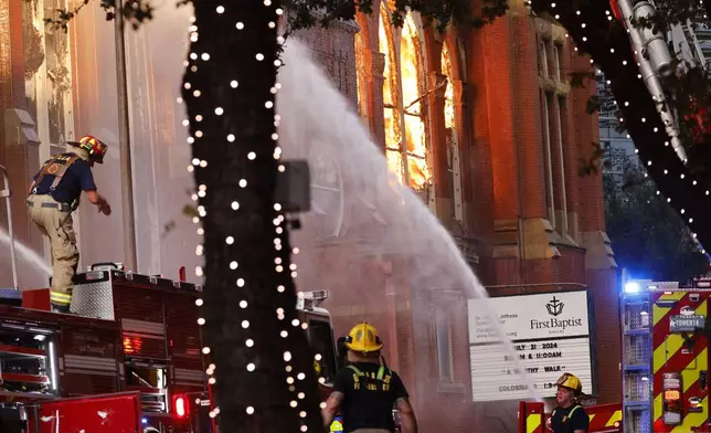 Firefighters battle a fire at First Baptist Dallas church on Friday, July 19, 2024, in downtown Dallas. (Chitose Suzuki/The Dallas Morning News via AP)