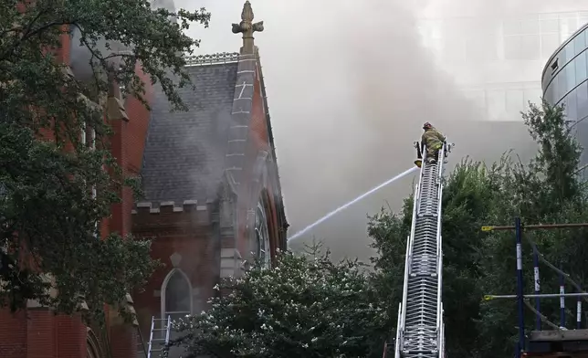 Firefighters work at the scene of a fire at First Baptist Dallas church on Friday, July 19, 2024, in downtown Dallas. (Chitose Suzuki/The Dallas Morning News via AP)