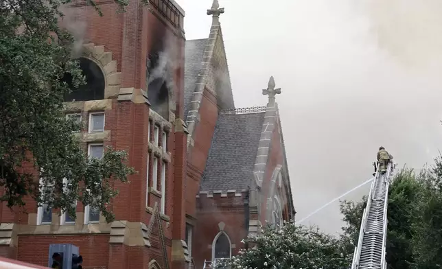 Firefighters work at the scene of a fire at First Baptist Dallas church on Friday, July 19, 2024, in downtown Dallas. (Chitose Suzuki/The Dallas Morning News via AP)