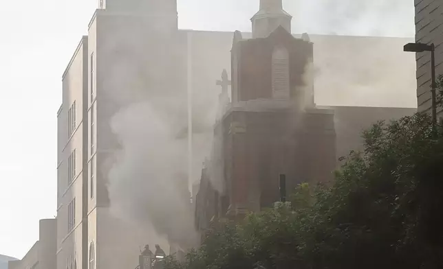 Firefighters work at the scene of a fire at First Baptist Dallas church on Friday, July 19, 2024, in downtown Dallas. (Chitose Suzuki/The Dallas Morning News via AP)