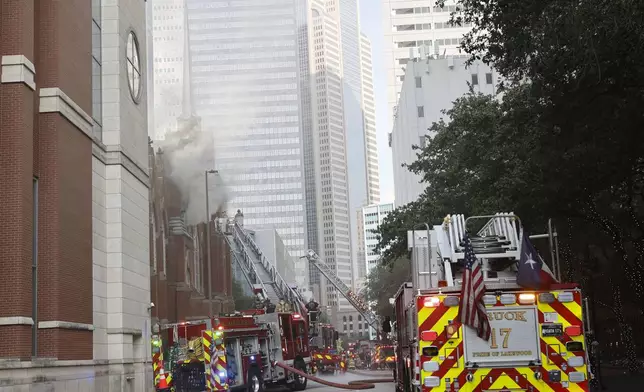 Firefighters work at the scene of a fire at First Baptist Dallas church on Friday, July 19, 2024, in downtown Dallas. (Chitose Suzuki/The Dallas Morning News via AP)