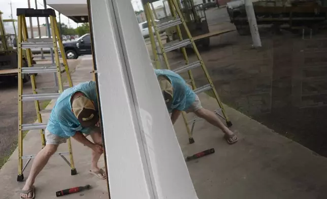 Jimmy May boards windows as he prepares for Hurricane Beryl's arrival, Sunday, July 7, 2024, in Port Lavaca, Texas. (AP Photo/Eric Gay)