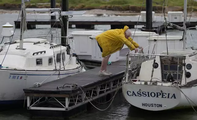 Ed Campbell works to secure his boat as he prepares for Beryl's arrival, Sunday, July 7, 2024, in Port Lavaca, Texas. Although Beryl remained a tropical storm Sunday as it churned toward Texas, it threatened to potentially regain hurricane strength in the warm waters of the Gulf of Mexico before making landfall early Monday. (AP Photo/Eric Gay)