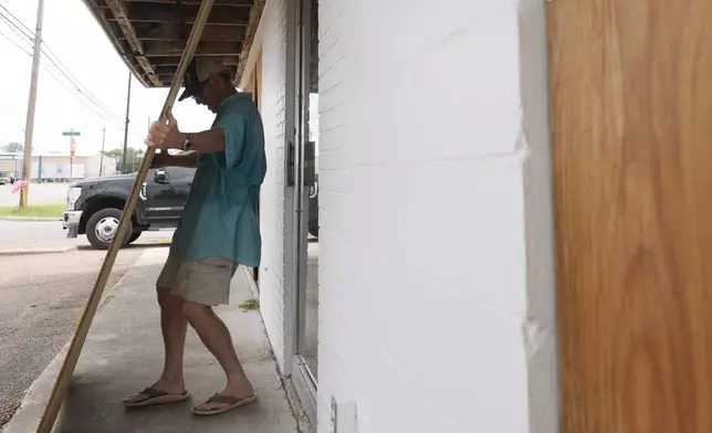 Jimmy May boards windows as he prepares for Hurricane Beryl's arrival, Sunday, July 7, 2024, in Port Lavaca, Texas. (AP Photo/Eric Gay)