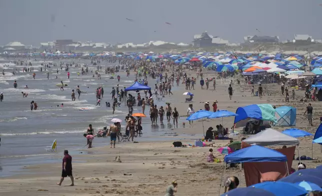 Visitors crowd the beaches, Saturday, July 6, 2024, in Port Aransas, Texas, ahead of Hurricane Beryl's arrival. (AP Photo/Eric Gay)