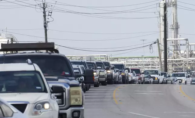 People wait in line for gas the day after Hurricane Beryl made landfall nearby Tuesday, July 9, 2024, in Freeport. (Jon Shapley/Houston Chronicle via AP)