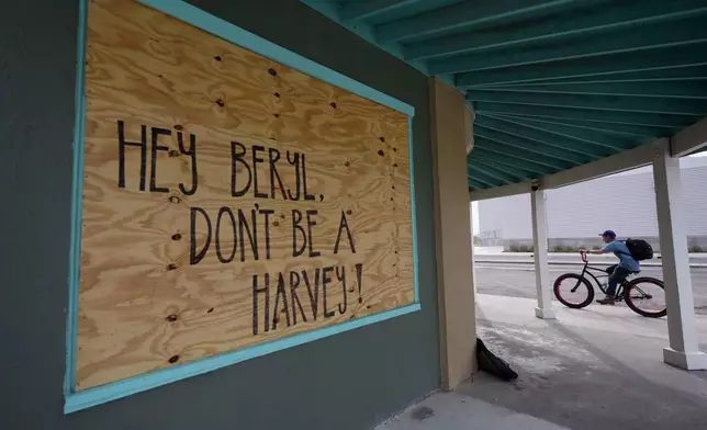 A message for Beryl is left on a boarded up business, Sunday, July 7, 2024, in Rock Port, Texas, as the storm moves closer to the Texas coast. (AP Photo/Eric Gay)