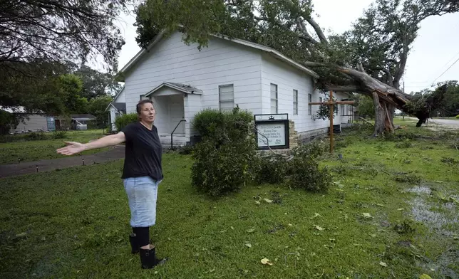 Ann McCauley examines the damage at Bethel Church after Hurricane Beryl moved through the area, Monday, July 8, 2024, in Van Vleck, Texas. (AP Photo/Eric Gay)