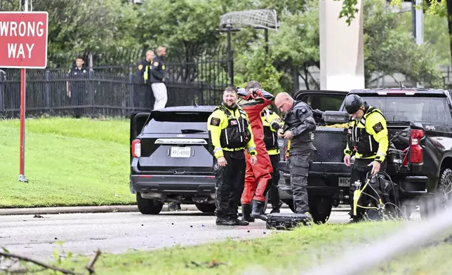 A rescue crew prepares in Houston, on Monday, July 8, 2024, after Beryl came ashore in Texas as a hurricane and dumped heavy rains downtown. (AP Photo/Maria Lysaker)