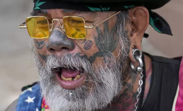 A cannabis activist joins a march outside Government House in Bangkok, Thailand, Monday, July 8, 2024. Two years after marijuana was decriminalized in Thailand, nearly a hundred of its advocates marched to the prime minister’s office Monday to protest a possible ban on general use. (AP Photo/Sakchai Lalit)