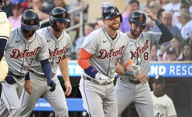 Detroit Tigers' Carson Kelly, second from right, returns to the dugout after hitting a grand slam, scoring Riley Greene (31), Colt Keith (33) and Matt Vierling (8) during the third inning of a baseball game Wednesday, July 3, 2024, in Minneapolis. The Tigers won 9-2. (AP Photo/Craig Lassig)