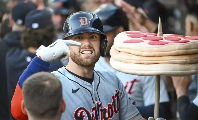 Detroit Tigers' Carson Kelly gestures as he celebrates in the dugout after hitting a grand slam home run against the Minnesota Twins during the third inning of a baseball game Wednesday, July 3, 2024, in Minneapolis.(AP Photo/Craig Lassig)