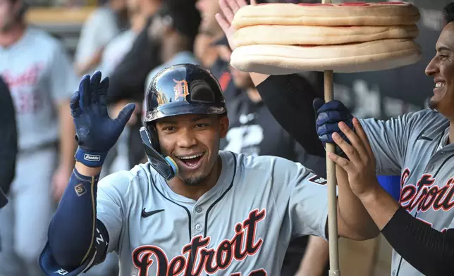Detroit Tigers right fielder Wenceel Perez (46) celebrates in the dugout after hitting a home run against the Minnesota Twins during the third inning of a baseball game Wednesday, July 3, 2024, in Minneapolis. (AP Photo/Craig Lassig)