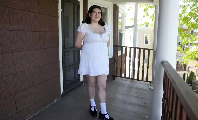 Daniella López White, of Hawaii, poses for a photo on Tuesday, May 14, 2024, on the porch of her apartment, in Boston. López White, who graduated from Emerson College in Boston this month and is on a tight budget, said TikTok influencers have helped her with tips on how to find affordable clothes at places like H&amp;M and thrift shops. (AP Photo/Steven Senne)