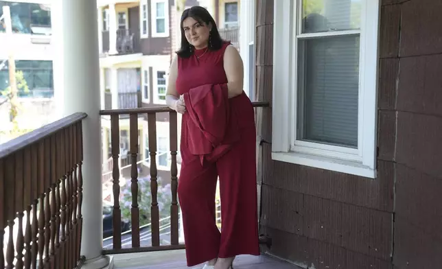 Daniella López White, of Hawaii, poses for a photo on Tuesday, May 14, 2024, on the porch of her apartment, in Boston. López White, who graduated from Emerson College in Boston this month and is on a tight budget, said TikTok influencers have helped her with tips on how to find affordable clothes at places like H&amp;M and thrift shops. (AP Photo/Steven Senne)