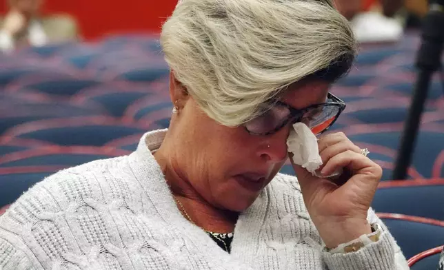 Jessica Norton, parent of a transgender student and volleyball player formerly of Monarch High School, reacts as the Broward County School Board discusses her daughter, during a meeting at Plantation High School, Tuesday, July 23, 2024. The board delayed voting on the mother's school district employment status for another week. (Joe Cavaretta/South Florida Sun-Sentinel via AP)