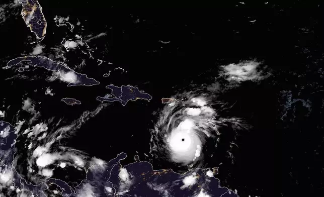 This National Oceanic and Atmospheric Administration satellite image taken at 10:50pm EDT shows hurricane Beryl, center, as it moves across the Caribbean on Monday, July 1, 2024. Hurricane Beryl has strengthened to Category 5 status as it crossed islands in the southeastern Caribbean. (NOAA via AP)