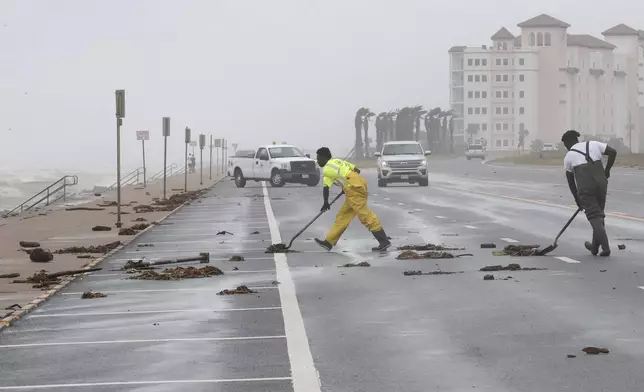 City of Galveston workers clear debris from Beryl from the West End of the seawall in Galveston, Texas, on Monday, July 8, 2024. Tropical Storm Beryl was unleashing heavy rains and powerful winds along the Texas coast, knocking out power to more than 2 million homes and businesses and flooding streets with fast-rising waters. (Jennifer Reynolds/The Galveston County Daily News via AP)