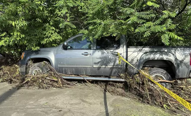 A truck sits damaged by flooding in Plainfield, Vermont, Thursday, July 11, 2024. (AP Photo/Lisa Rathke)