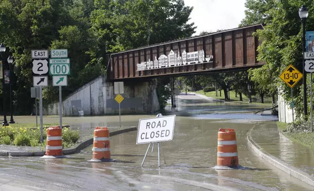 Water floods a street, Thursday, July 11, 2024, in Waterbury, Vt. (AP Photo/Hasan Jamali)