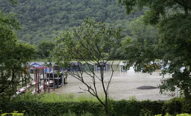 Water floods the lower level of homes, Thursday, July 11, 2024, in Bolton, Vt., near the Winooski River. (AP Photo/Hasan Jamali)