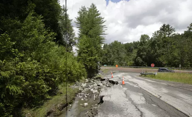 Flooding washes out a road, Thursday, July 11, 2024, in Barre, Vt. (AP Photo/Hasan Jamali)