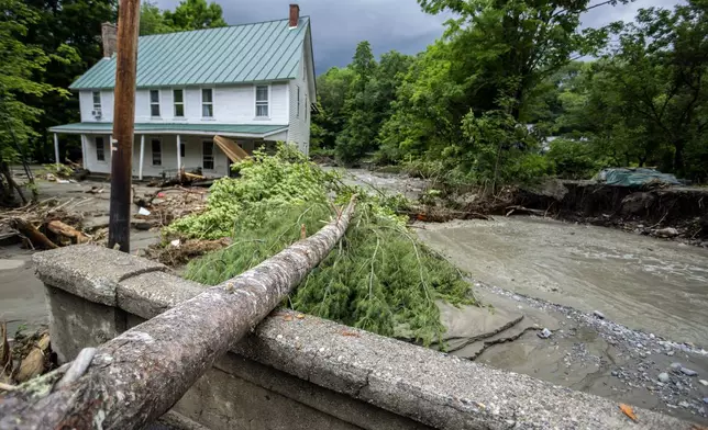 Debris is strewn about a damaged bridge over the Winooski River following flooding caused by the remnants of Hurricane Beryl, Thursday, July 11, 2024, in Plainfield, Vt. (AP Photo/Dmitry Belyakov)