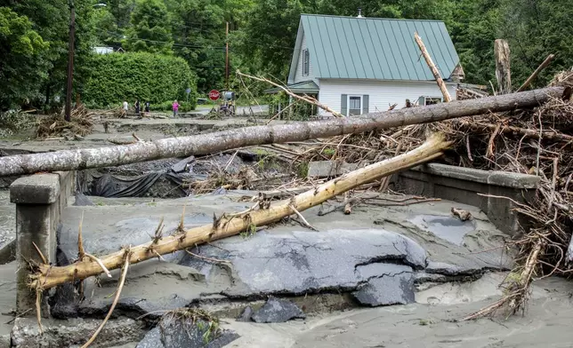 Debris is strewn about a damaged bridge over the Winooski River following flooding caused by the remnants of Hurricane Beryl, Thursday, July 11, 2024, in Plainfield, Vt. (AP Photo/Dmitry Belyakov)